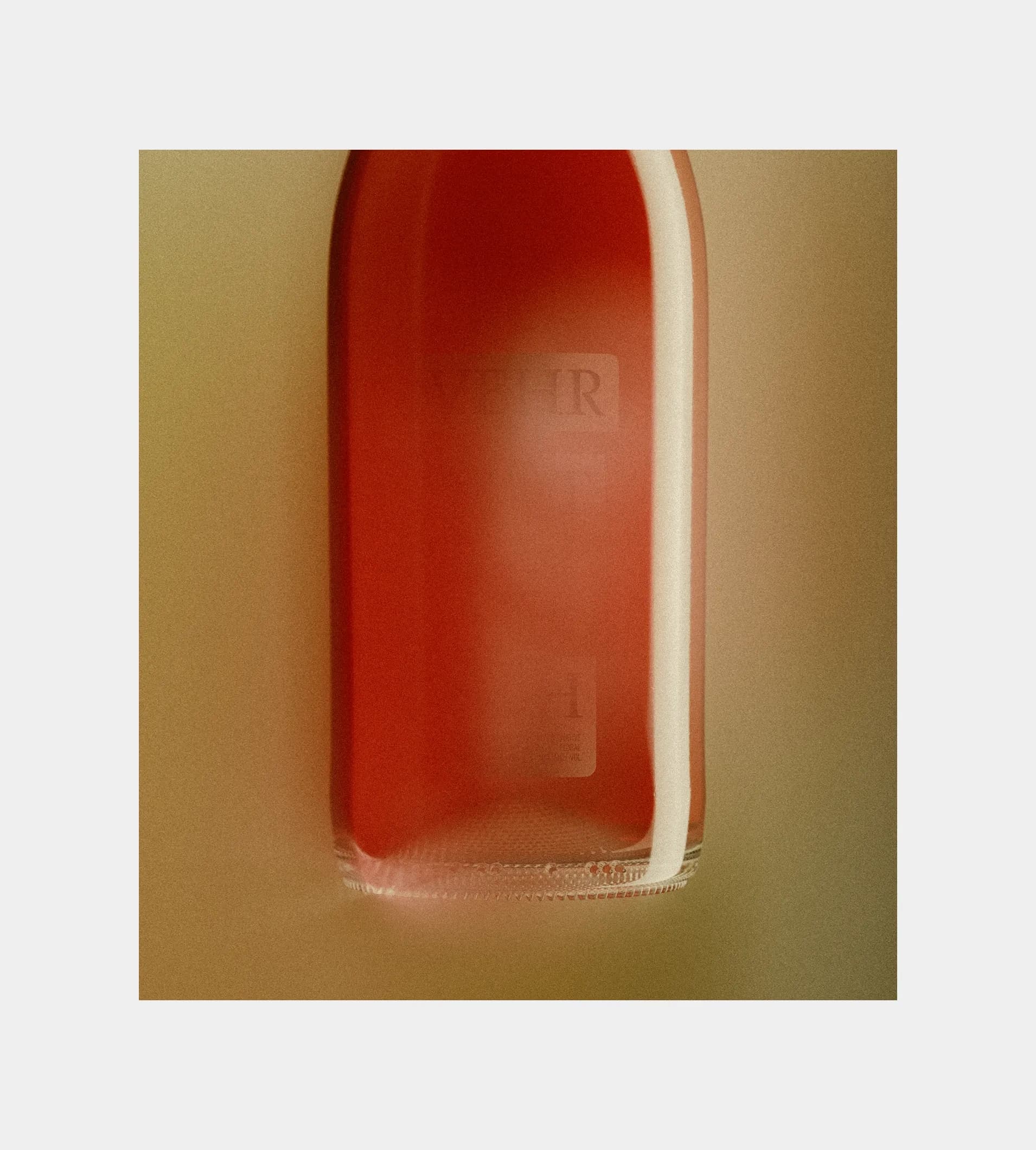Experimental close-up of a Shwung bottle bottom showing the label system wrapping around the base.