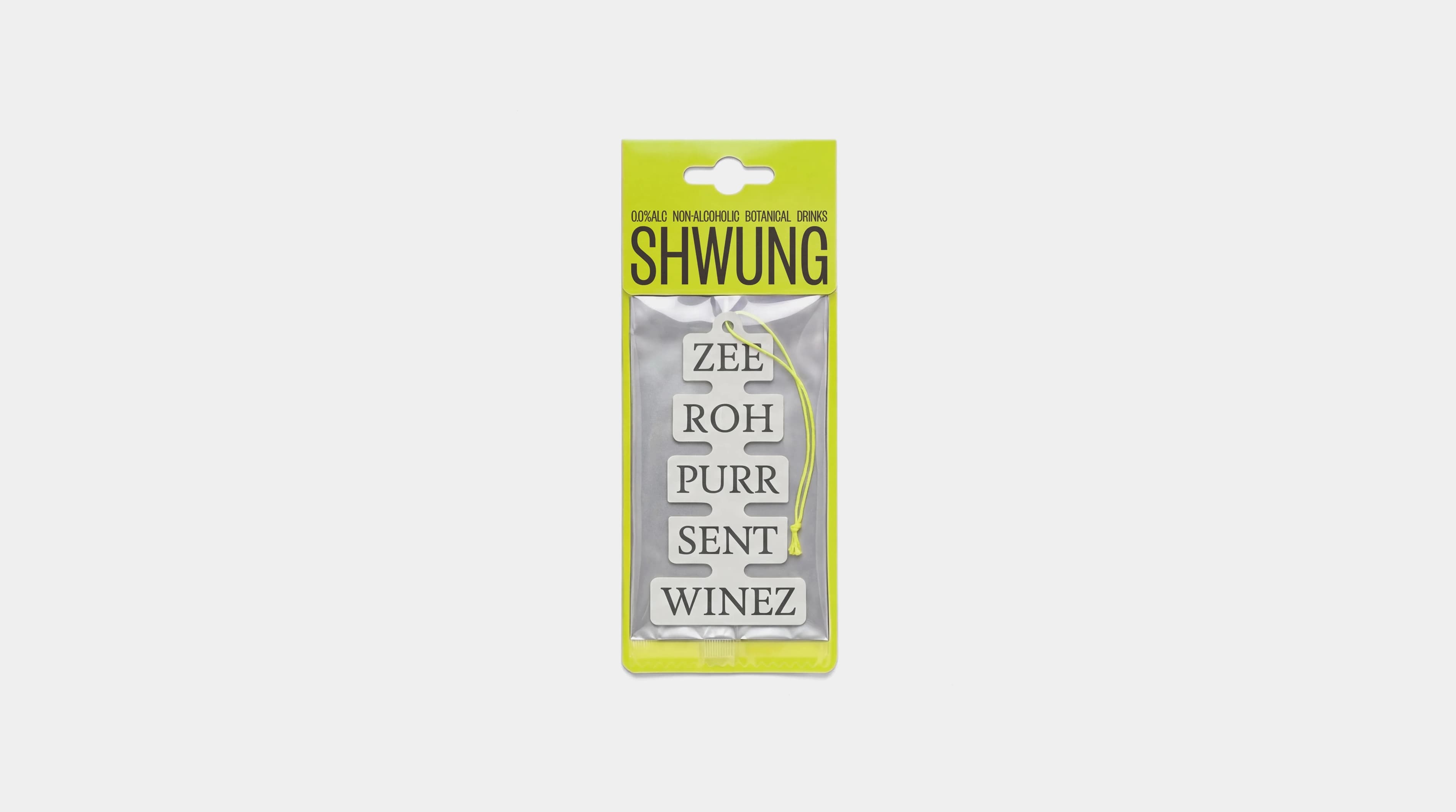 Shwung branded car air freshener in the die-cut label shape, packaged in yellow-green with the phonetic spelling "ZEE ROH PURR SENT WINEZ" stacked down the front.