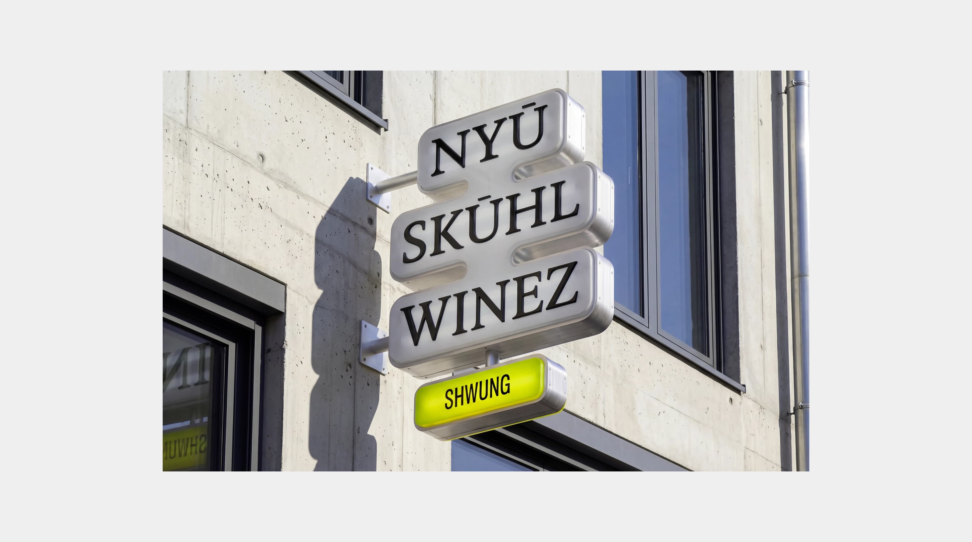 Shwung signage on a building facade reading "NYU SKUHL WINEZ", showing the identity applied to environmental graphics.